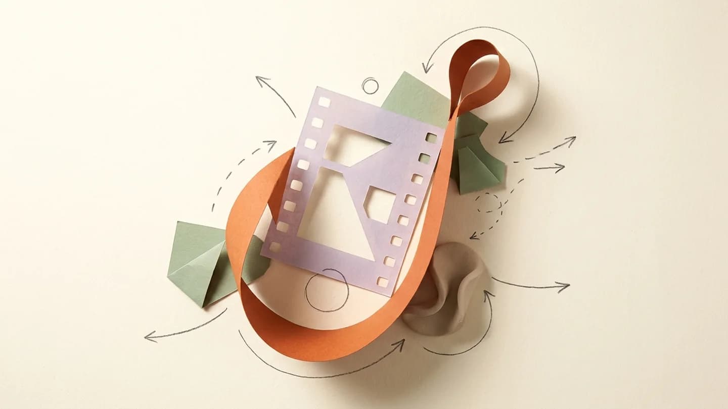 A large orange fishing-hook-shaped paper curl gently catching a lavender film frame, sage paper accents, conceptual editorial still life.